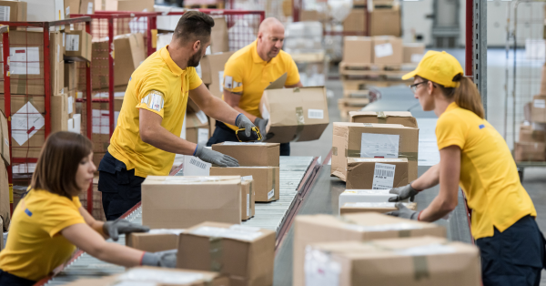 people are custom kitting and packing products in the warehouse