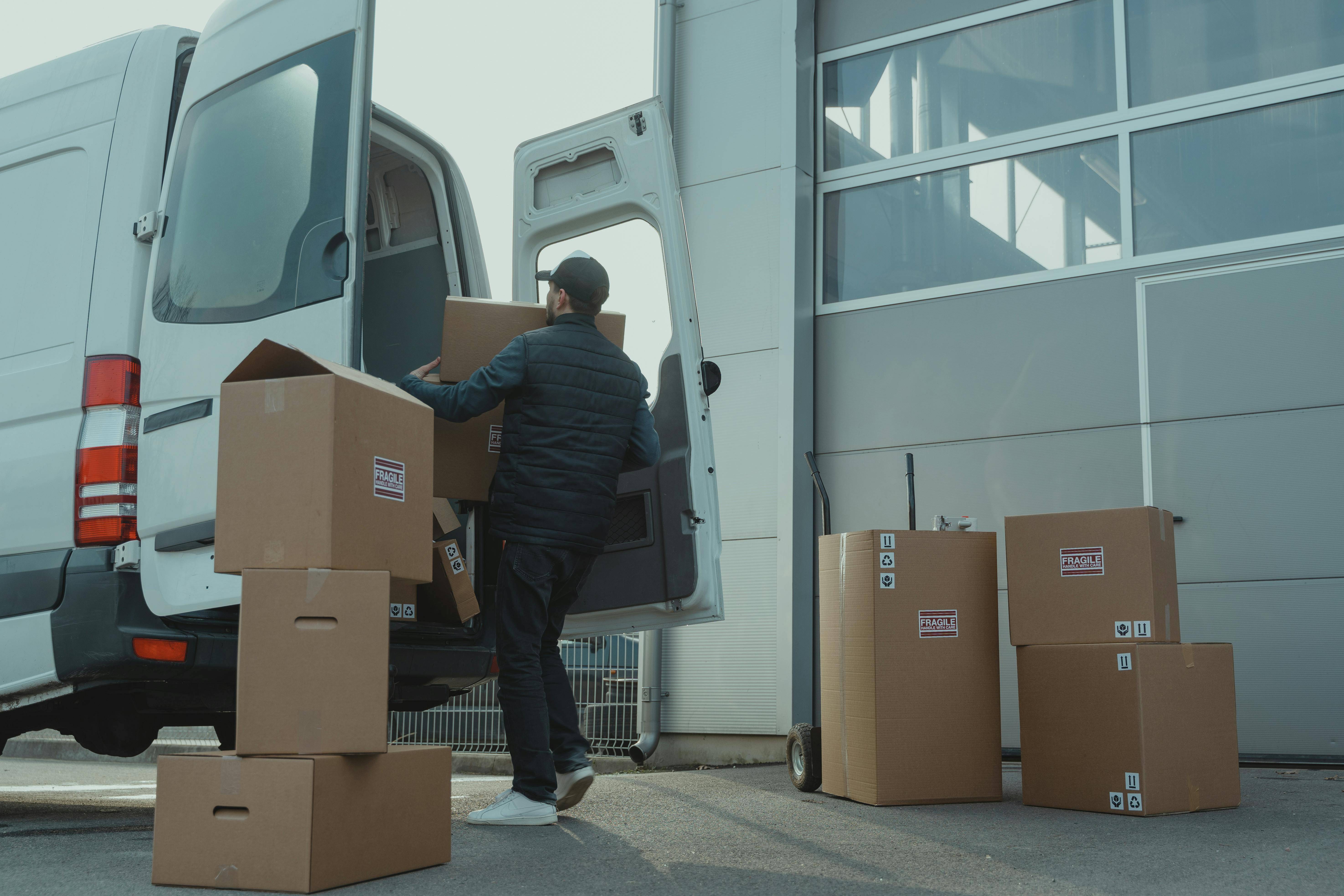 a man carrying a package to the car